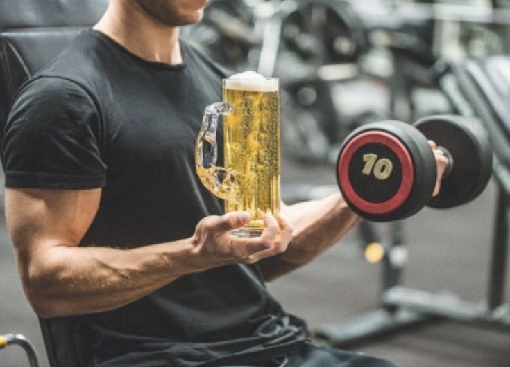 A funny beer mug dumbbell meme highlighting how alcohol causes muscle loss and disrupts protein synthesis when working out the day after drinking.